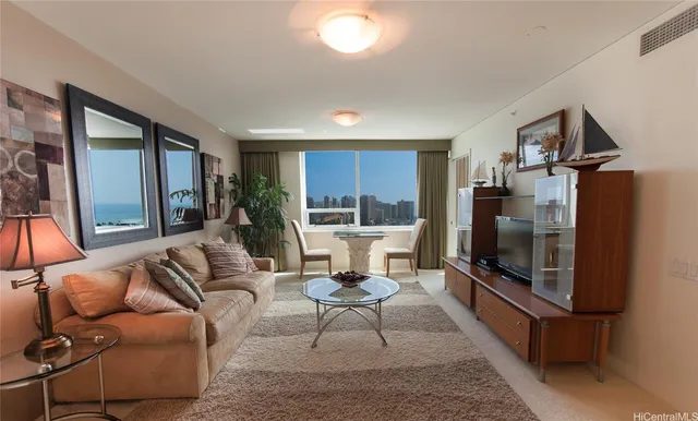 a living room with furniture a flat screen tv and a fireplace