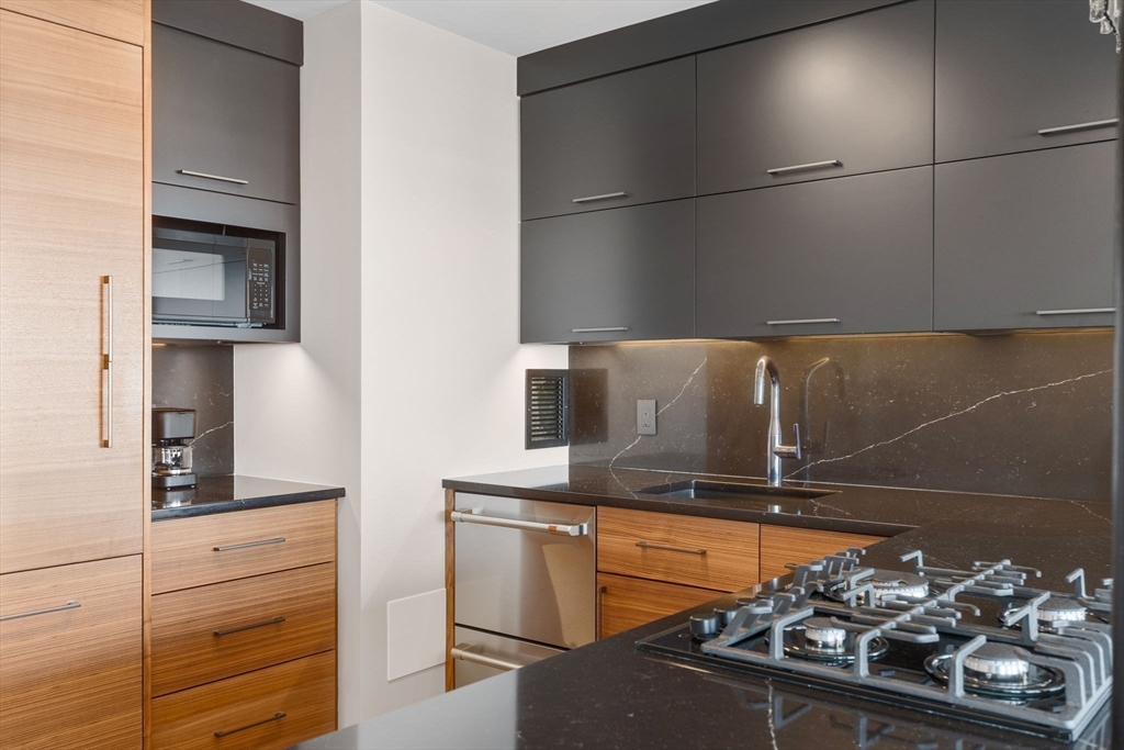 85 East India Row, Unit 38H Boston, MA 02110 - Photo 3 of 15 a kitchen with a sink and cabinets