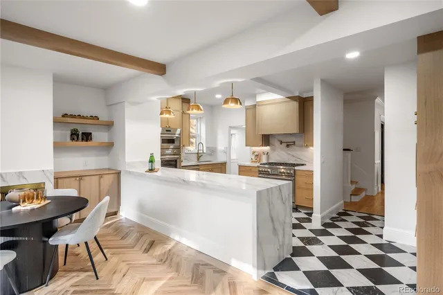 a kitchen with a sink a stove a dining table and chairs