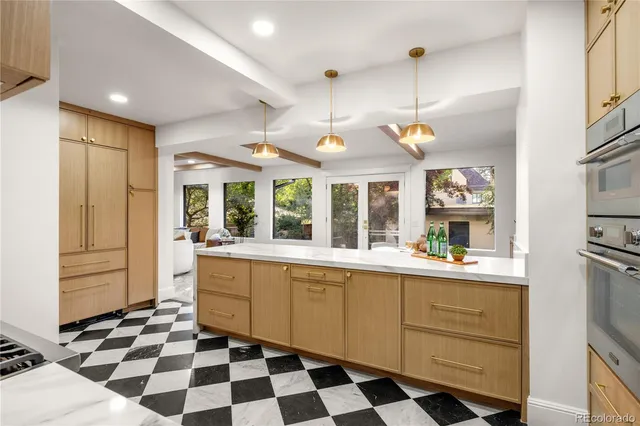 a kitchen with a checkered floor and white cabinets