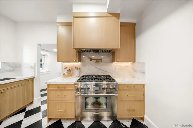 a kitchen with a stove and a refrigerator