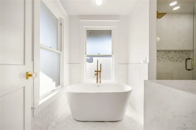 a white bath tub sitting in a bathroom