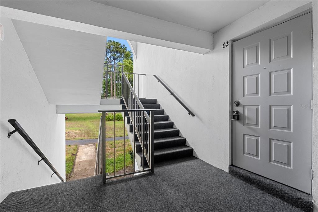 8203 Sun Spring Circle, Unit 62 Orlando, FL 32825 - Photo 2 of 19 a view of an entryway with staircase