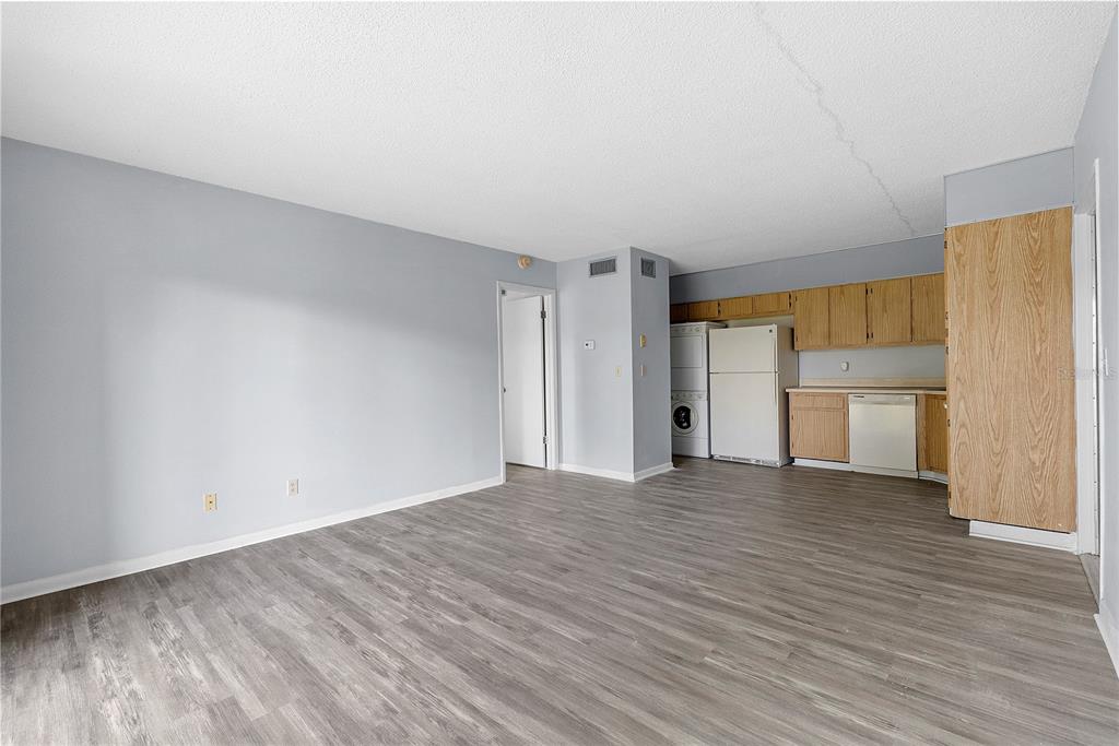 8203 Sun Spring Circle, Unit 62 Orlando, FL 32825 - Photo 5 of 19 a view of empty room with wooden floor and kitchen