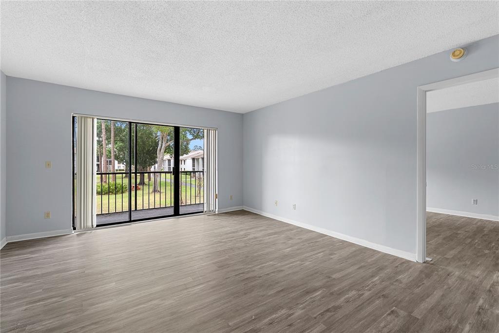 8203 Sun Spring Circle, Unit 62 Orlando, FL 32825 - Photo 6 of 19 a view of a big room with wooden floor and windows