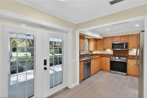 a kitchen with a sink stove top oven and cabinets