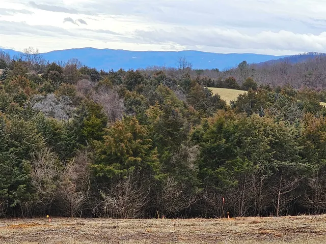 a view of mountain with sunset in background