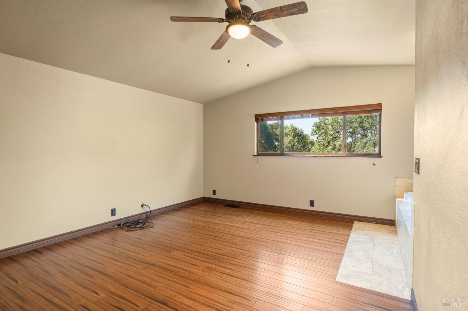 888 Watson Road Ukiah, CA 95482 - Photo 16 of 39 an empty room with wooden floor and windows