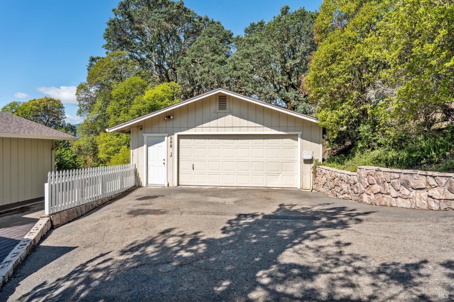 888 Watson Road Ukiah, CA 95482 - Photo 32 of 39 a front view of a house with a yard and garage