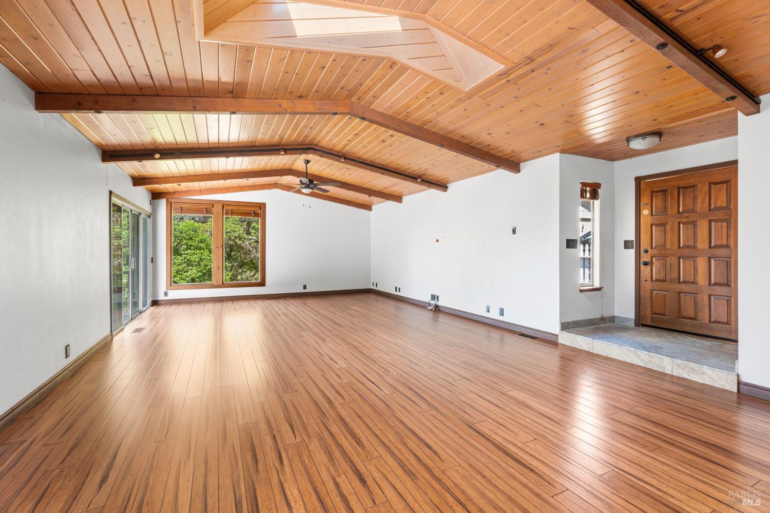 888 Watson Road Ukiah, CA 95482 - Photo 4 of 39 an empty room with wooden floor and windows