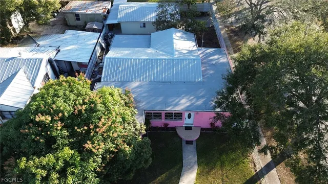 an aerial view of a city with lots of residential buildings and parking space
