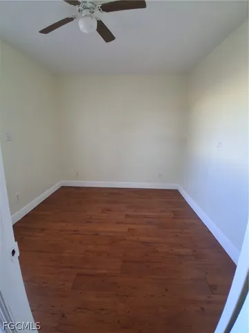 a view of a yard with wooden fence