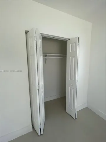 a bathroom with a toilet sink vanity and shower