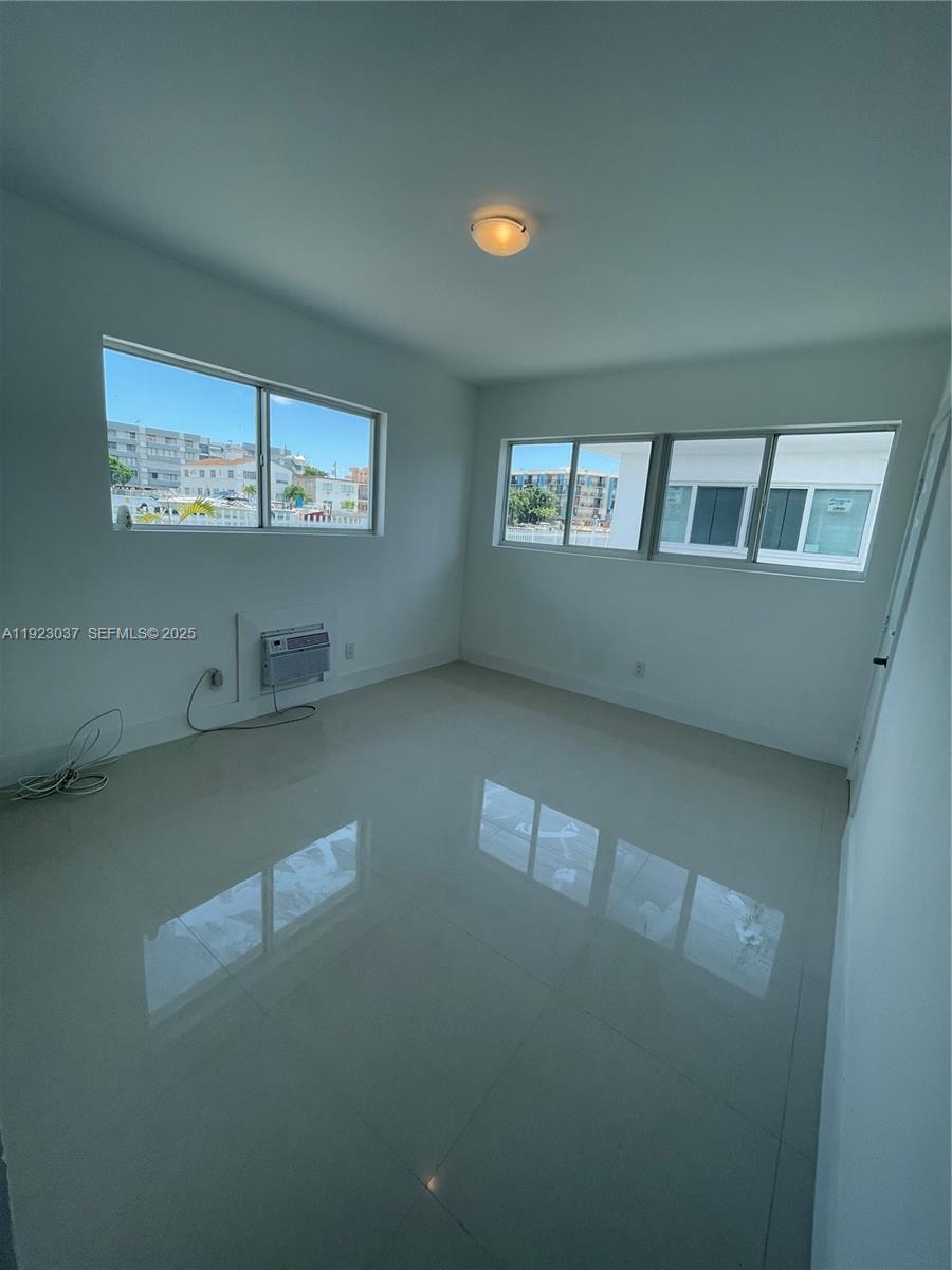 8215 Crespi Boulevard, Unit 4 Miami Beach, FL 33141 - Photo 18 of 34 an empty room with windows