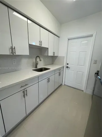 a kitchen with a sink and cabinets
