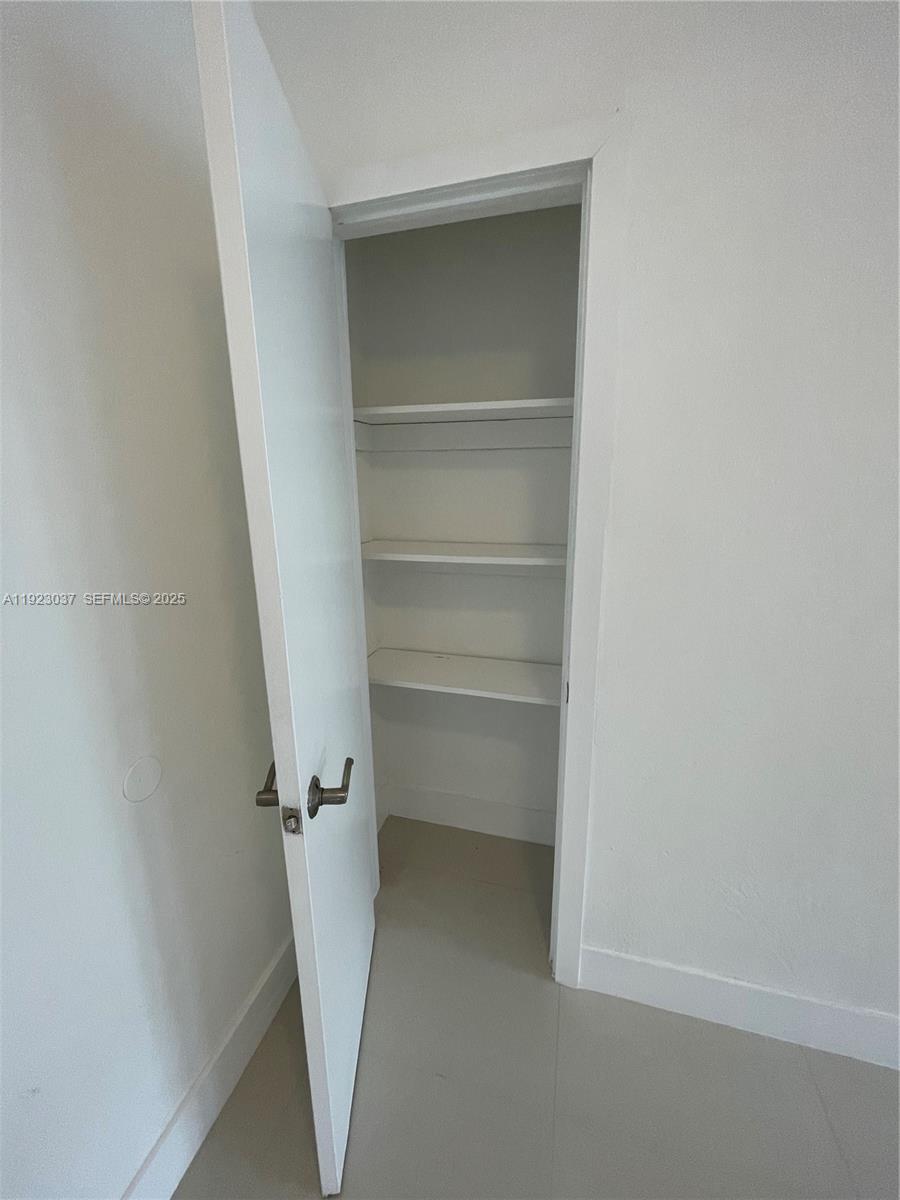 8215 Crespi Boulevard, Unit 4 Miami Beach, FL 33141 - Photo 8 of 34 a view of walk in closet with empty racks