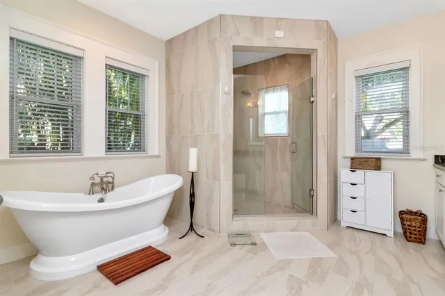 a spacious bathroom with a bathtub and shower