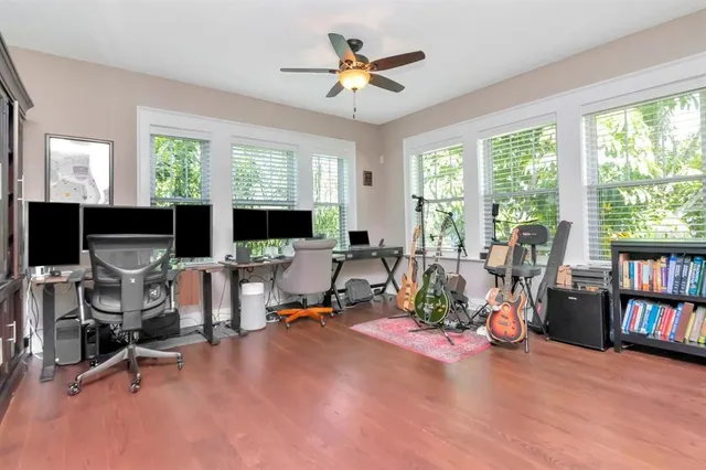 a view of a livingroom with workspace and a window