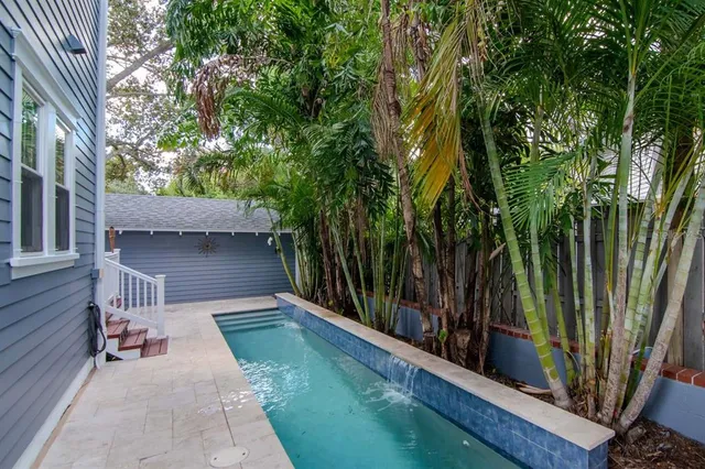 a view of backyard with green space and deck