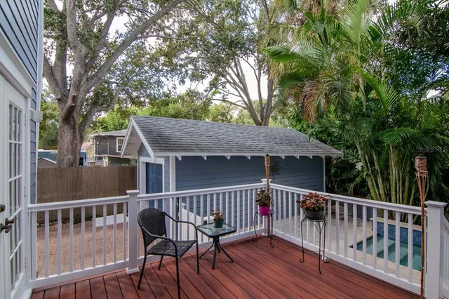 a balcony with wooden floor and fence