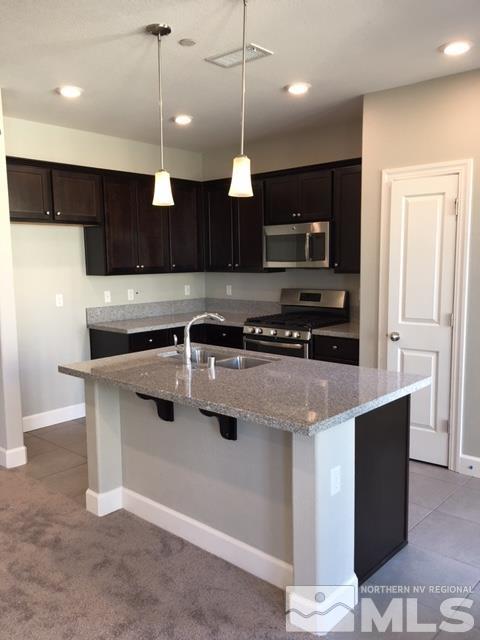 2037 Wind Ranch Road, Unit A (LOT 71) Reno, NV 89521 - Photo 1 of 1 a kitchen with stainless steel appliances granite countertop a stove a sink and a microwave