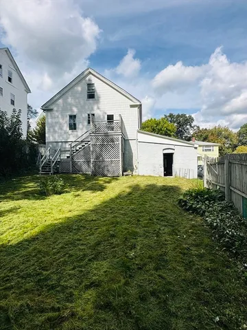 a house view with a big yard plants and large trees