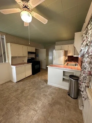 a view of a kitchen with a stove cabinets