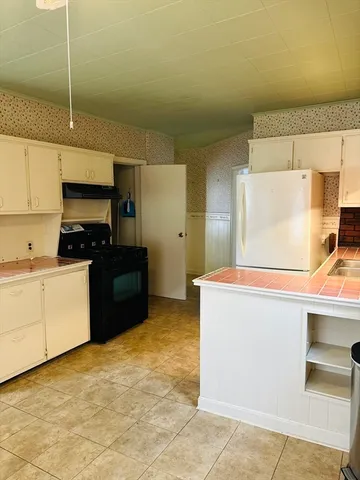 a kitchen with stainless steel appliances a stove a sink and a refrigerator