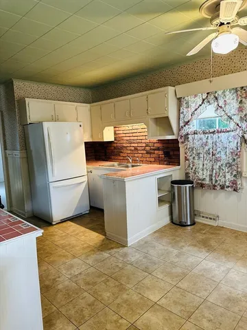 a kitchen with stainless steel appliances a stove a refrigerator and a sink