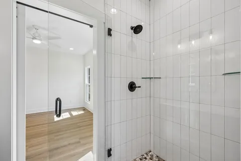 a bathroom with a double vanity sink a mirror and shower