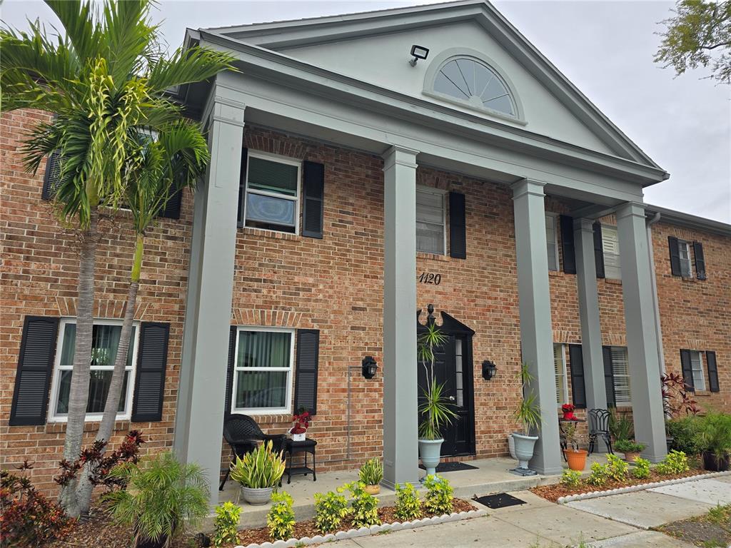 a front view of a house with plants