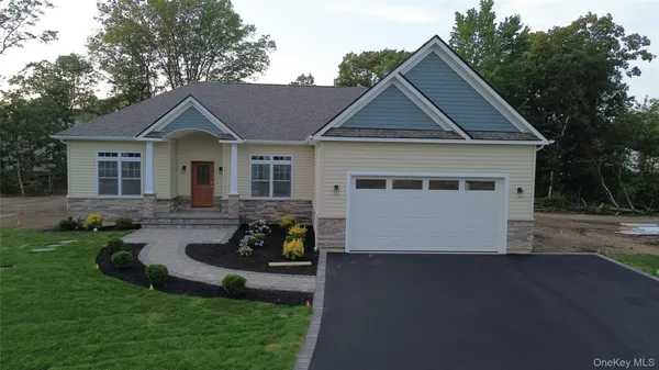 a view of a house with a yard and lawn chairs