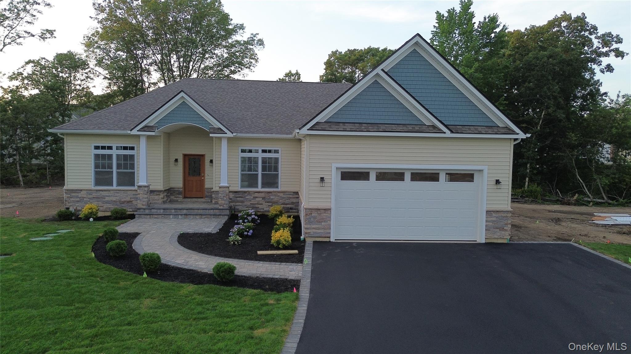 a view of a house with a yard and lawn chairs