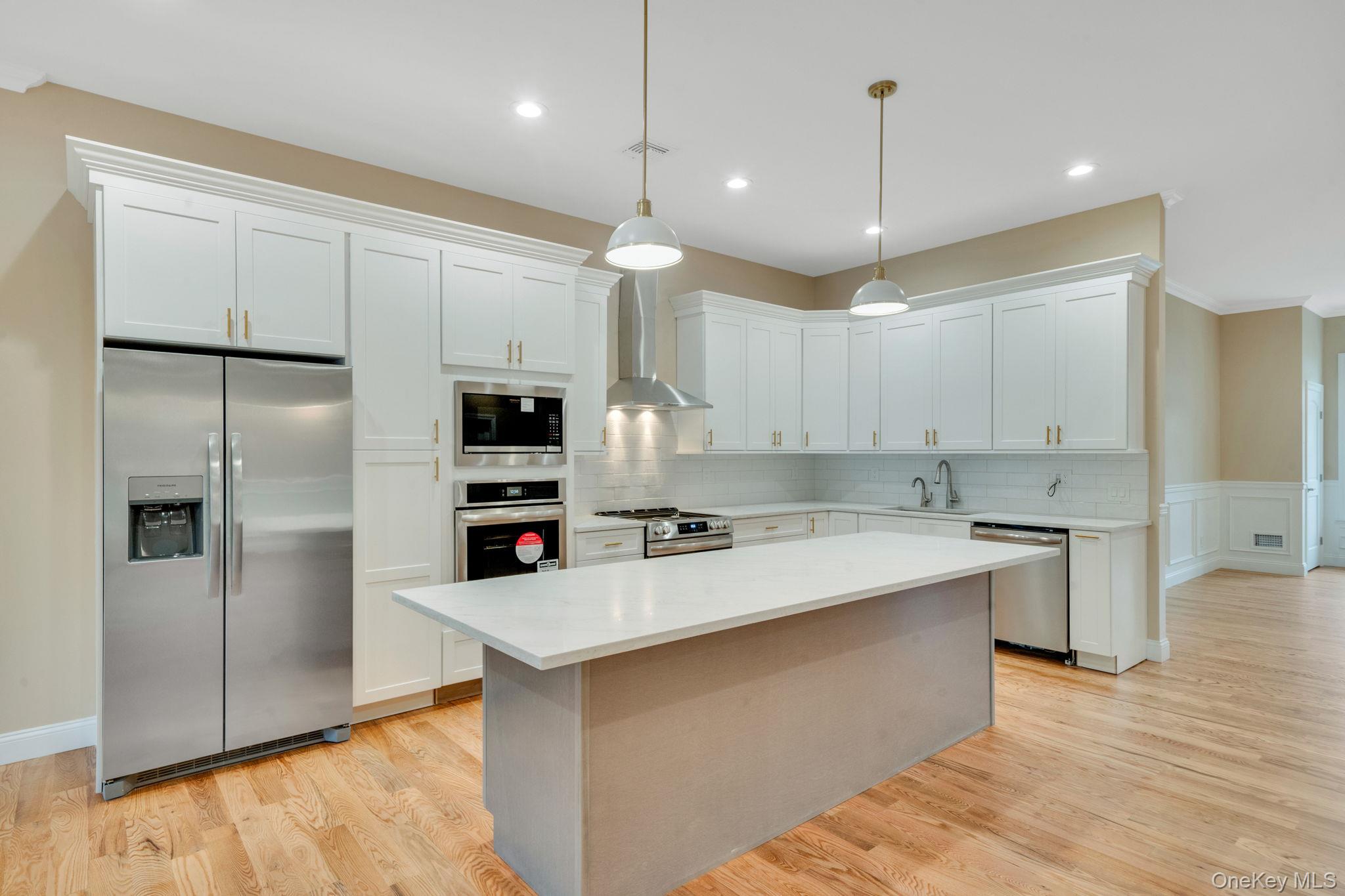 64 Blydenburgh Road Centereach, NY 11720 - Photo 10 of 29 a kitchen with a refrigerator a sink and a oven