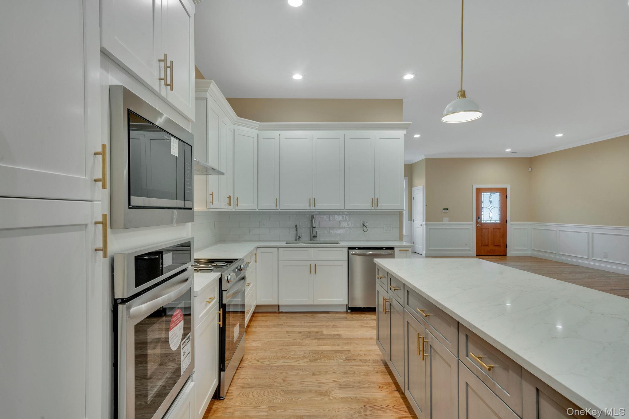 64 Blydenburgh Road Centereach, NY 11720 - Photo 11 of 29 a kitchen with a sink stainless steel appliances and cabinets