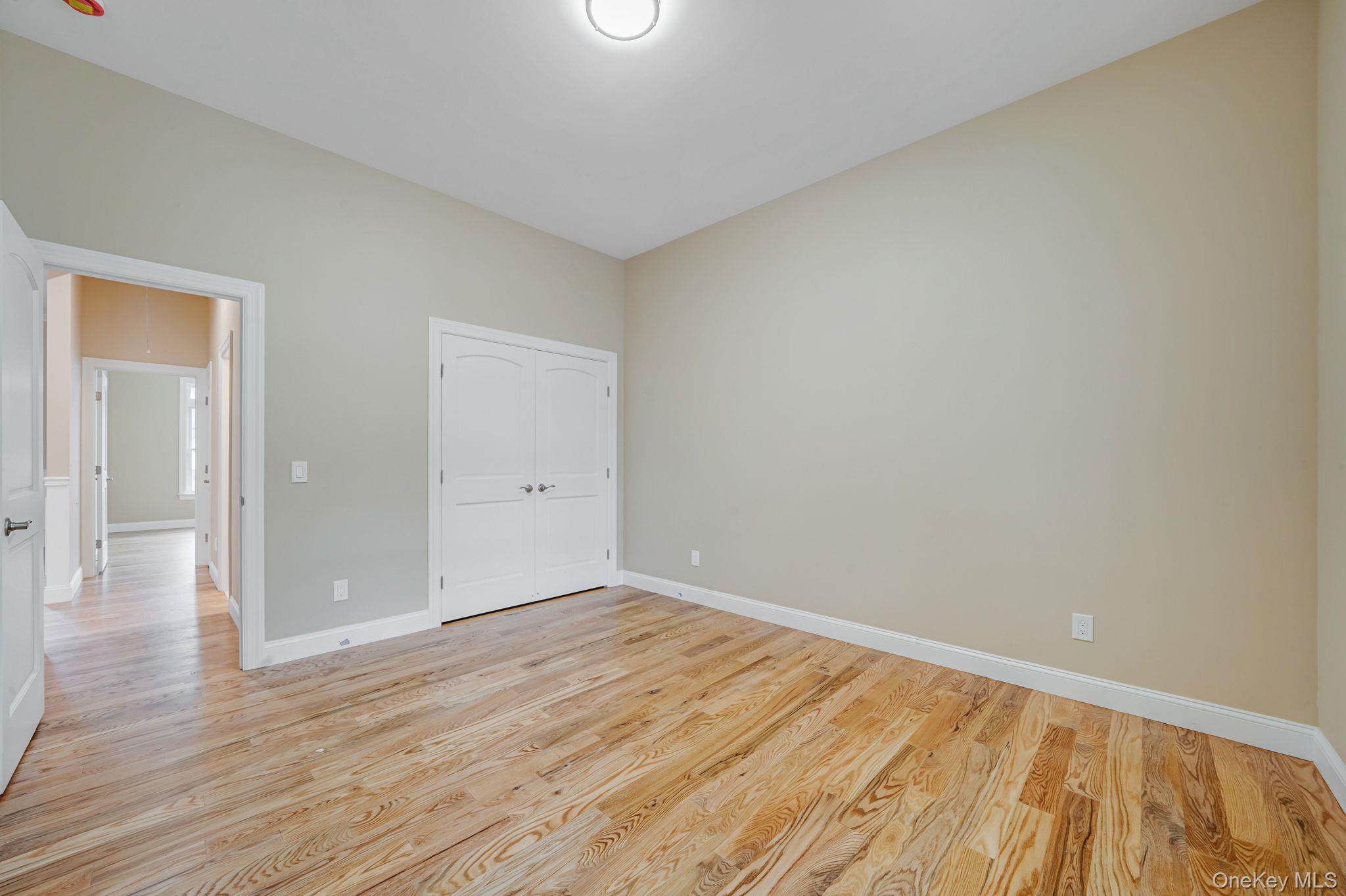 64 Blydenburgh Road Centereach, NY 11720 - Photo 12 of 29 wooden floor in an empty room
