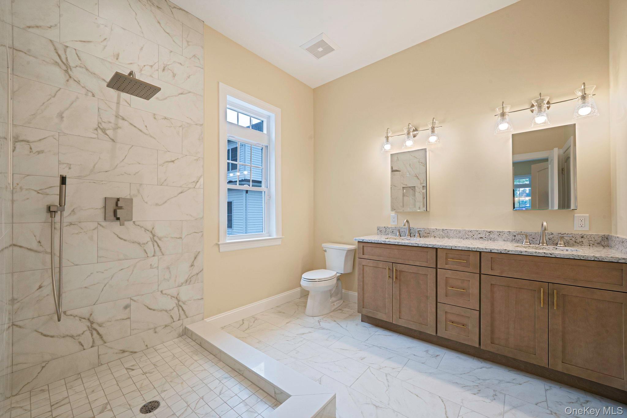 64 Blydenburgh Road Centereach, NY 11720 - Photo 18 of 29 a bathroom with a granite countertop sink toilet a large mirror a shower and a bathtub