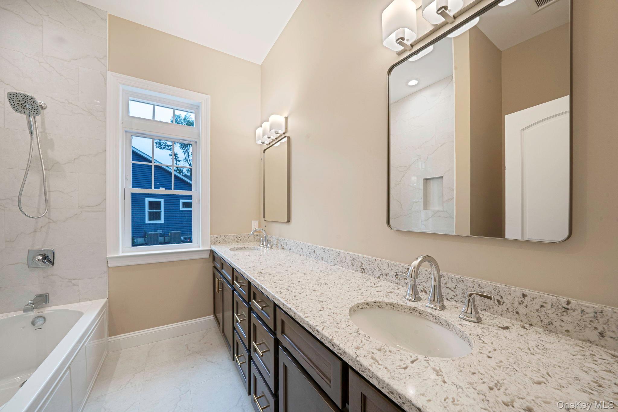 64 Blydenburgh Road Centereach, NY 11720 - Photo 19 of 29 a bathroom with a granite countertop sink mirror and a bathtub