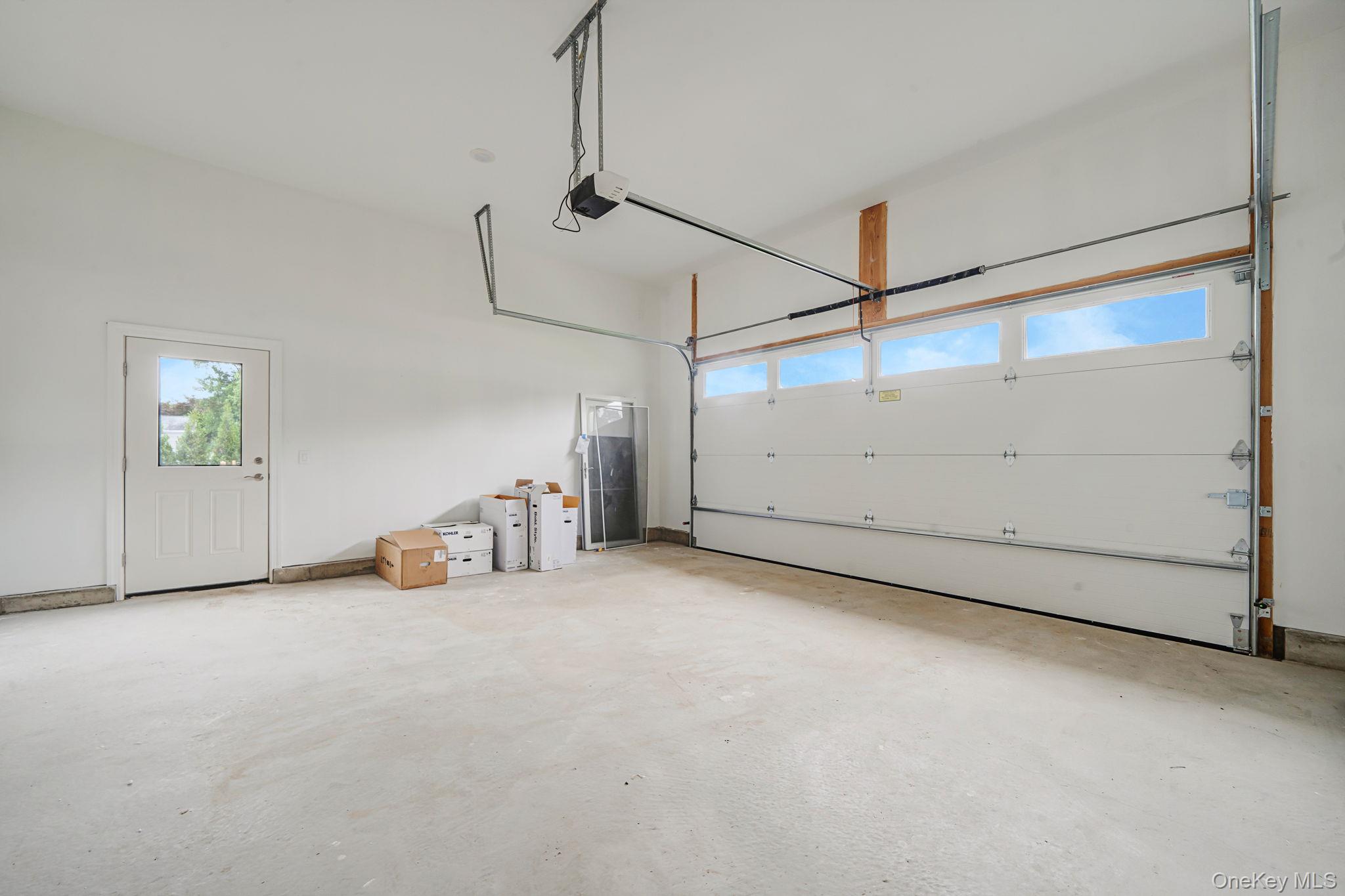 64 Blydenburgh Road Centereach, NY 11720 - Photo 21 of 29 a view of a room with an entryway and chandelier
