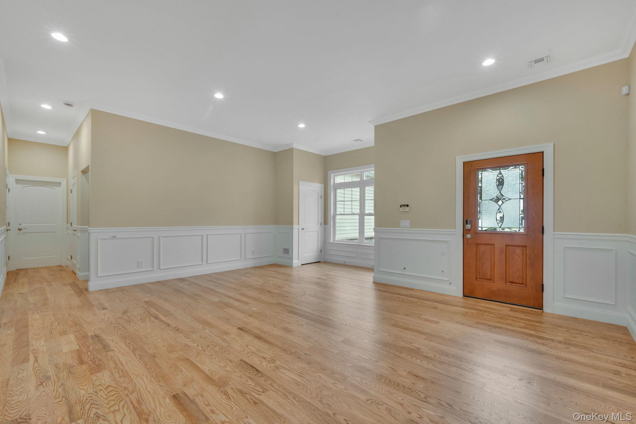 64 Blydenburgh Road Centereach, NY 11720 - Photo 4 of 29 a view of an empty room with wooden floor and windows