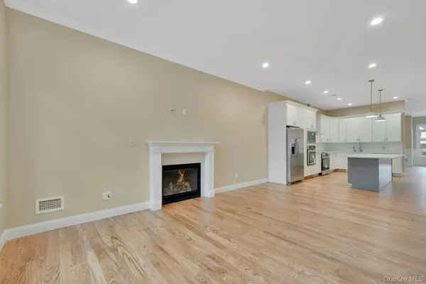 a view of a kitchen with a sink and a fireplace