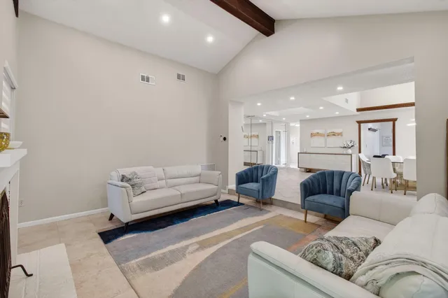 a kitchen with granite countertop white cabinets and stainless steel appliances