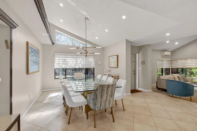 a bedroom with two beds and a chandelier