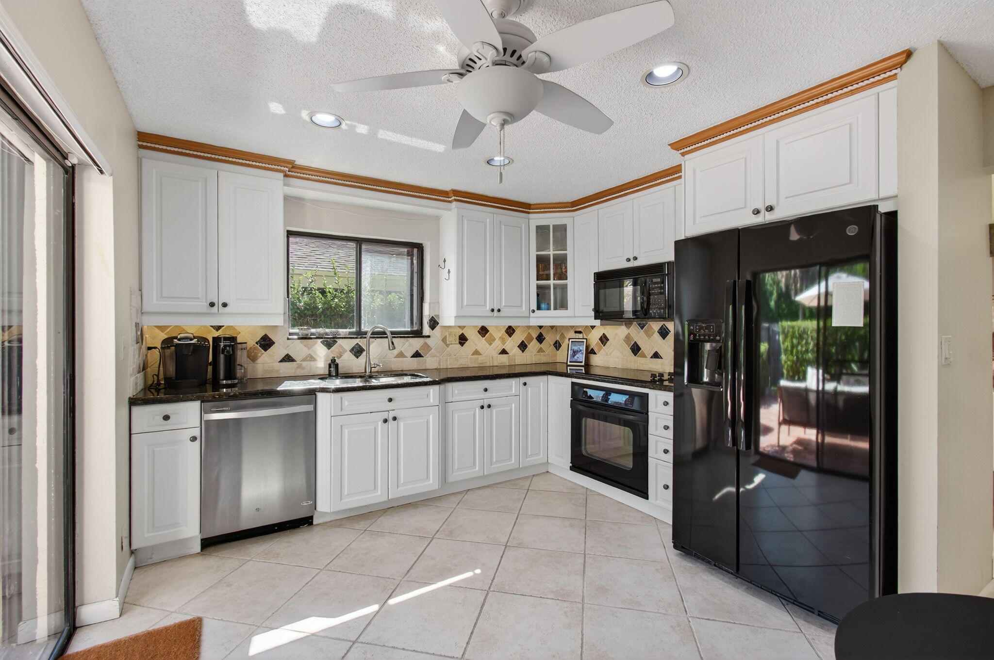 7745 Stanway Place Boca Raton, FL 33433 - Photo 25 of 90 a kitchen with stainless steel appliances granite countertop a sink and refrigerator