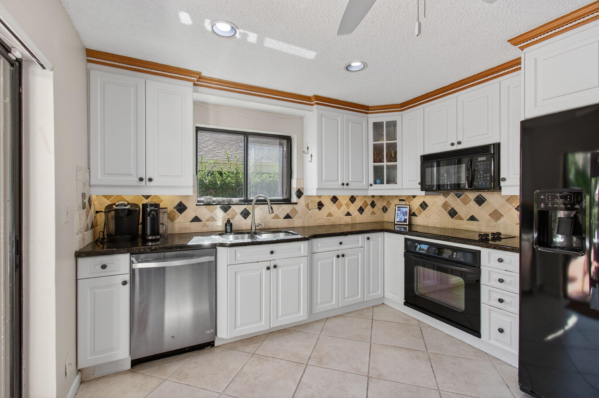 7745 Stanway Place Boca Raton, FL 33433 - Photo 26 of 90 a kitchen with stainless steel appliances granite countertop a sink and dishwasher a stove top oven with wooden floor