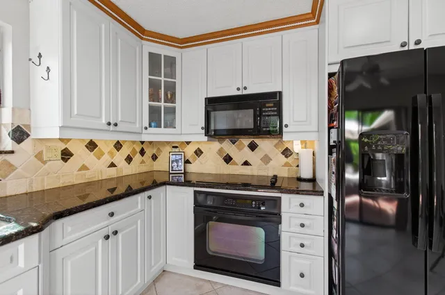 a bedroom with two beds and a lamp on a dresser