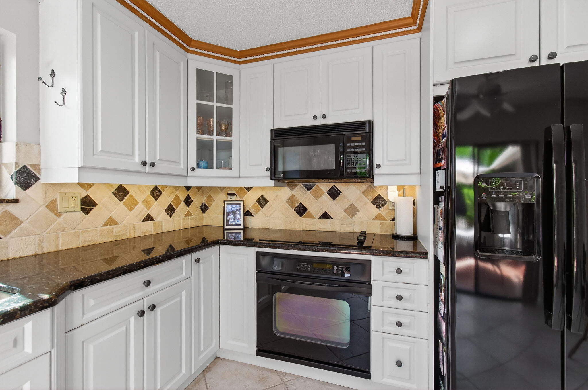 7745 Stanway Place Boca Raton, FL 33433 - Photo 30 of 90 a kitchen with granite countertop white cabinets and stainless steel appliances