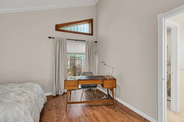 a view of a patio with furniture and table under an umbrella