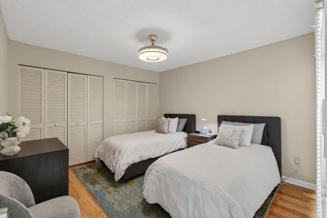 an aerial view of residential houses with outdoor space and trees