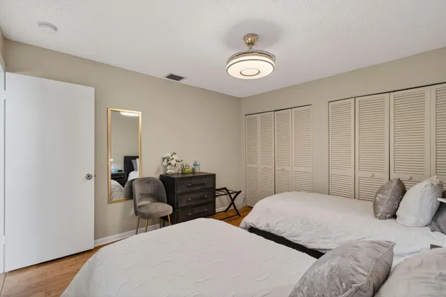 an aerial view of residential houses with outdoor space and trees